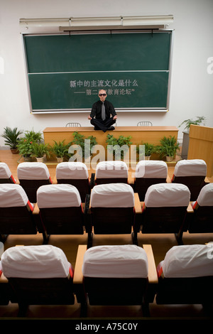 Teacher meditating on desk Stock Photo