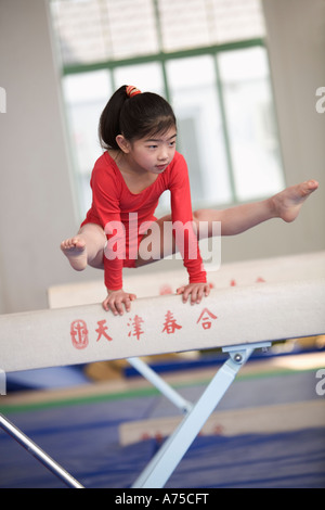 Young girl practicing gymnastics Stock Photo