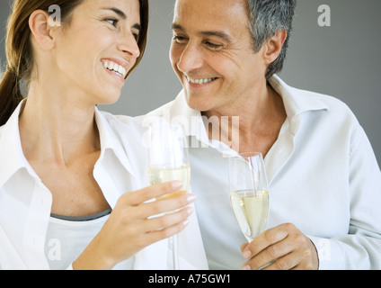 Couple holding champagne flutes Stock Photo