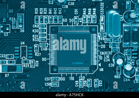 Microchips on circuit board close up blue tone Stock Photo