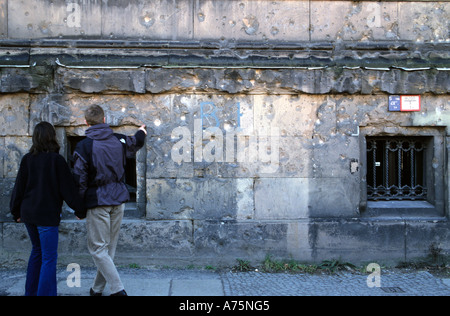 Tourist point at World War Two bullet holes in Berlin facade Stock Photo