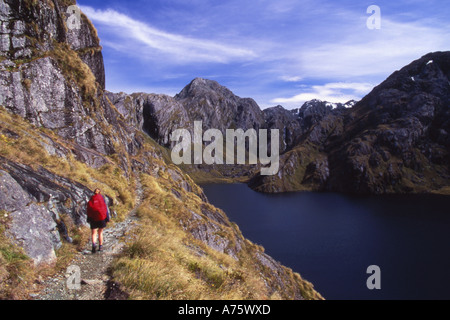 Tramper on The Routeburn Track at Lake Harris with Conical Hill in the Distance Mt Aspiring National Park New Zealand Stock Photo