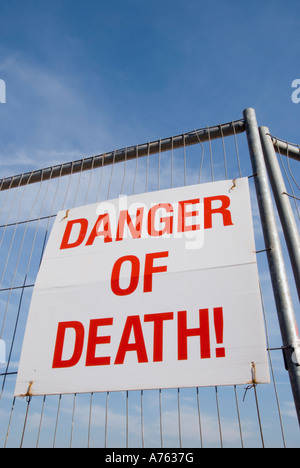 A sign  on a  construction site fence  reads - DANGER OF DEATH