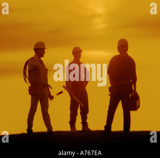 Workmen on construction site at sunrise Stock Photo
