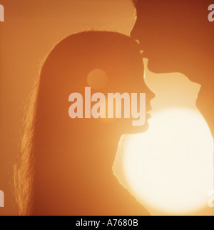 romantic couple embracing at sunset Stock Photo