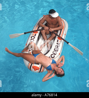 couple relaxing on raft in tropical ocean Stock Photo