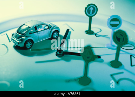 Miniature Traffic Signs and Car on Clock Stock Photo