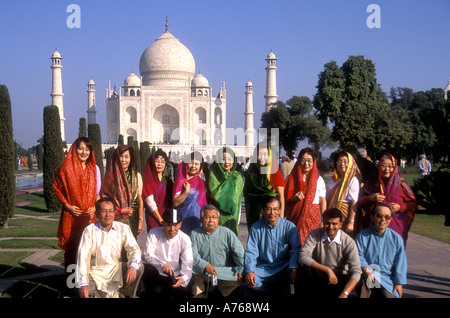 Japanese tourists posing for a photograph in front of the Taj Mahal Agra India Stock Photo