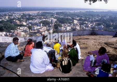 An Indian family having a picnic and enjoying the view from the summit of the Rock Fort over Tiruchirapalli Tamil Nadu India Stock Photo