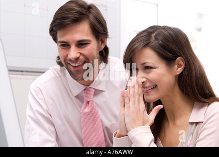 Man and woman in office, smiling, close-up Stock Photo