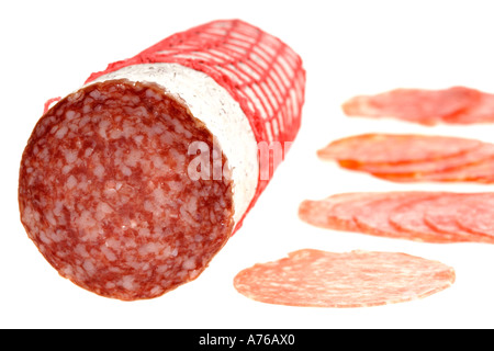 A whole Sopressata Italian salami sausage and slices of different types of salami on a pure white background. Stock Photo