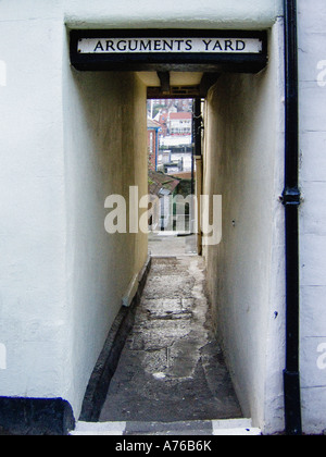 Arguments Yard sign about a narrow alleyway between two buildings on Church Street in Whitby, North Yorkshire. UK Stock Photo