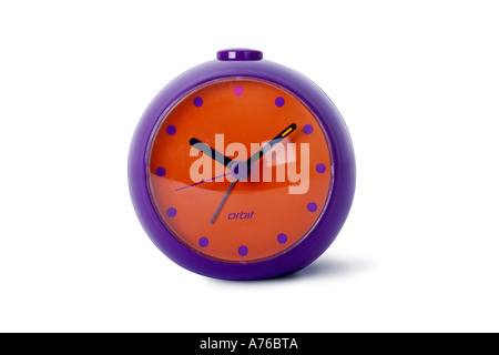 Colourful purple and red orange alarm clock on a pure white background. Stock Photo