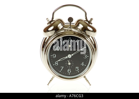 Traditional chrome alarm clock on a pure white background. Stock Photo