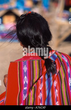 Young Quechuan woman girl with braided hair and colourful traditional clothes , near Cusco , Peru Stock Photo