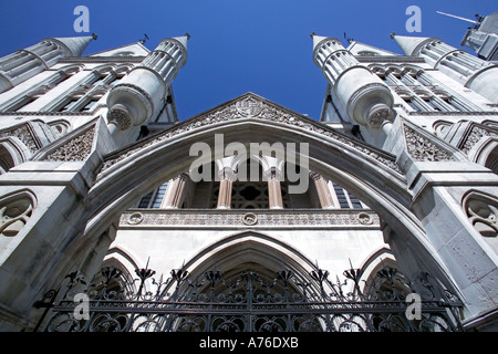 Close up wide angle view of the main entrance to the Royal Courts of Justice aka Law Courts against a blue sky. Stock Photo