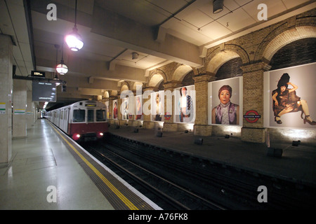 A tube train coming into an empty platform with motion blur at Gloucester Road underground station. Stock Photo