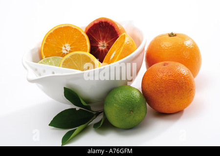 Sliced citrus fruits in bowl Stock Photo