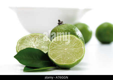 Lime fruits infront of bowl Stock Photo