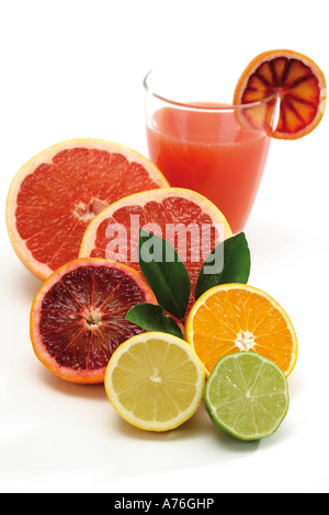Various citrus fruits by glass of juice Stock Photo