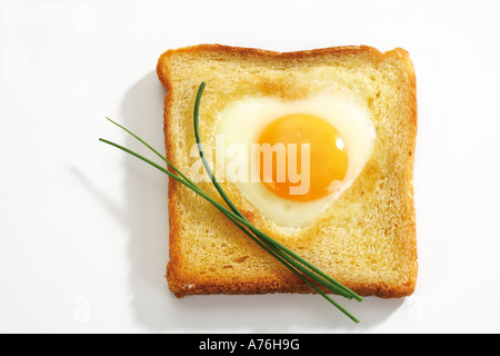 Fried egg (heart shape) in toast bread, elevated view Stock Photo