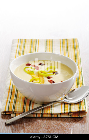 Rutabaga vegetable cream soup with bacon on napkin, spoon aside Stock Photo