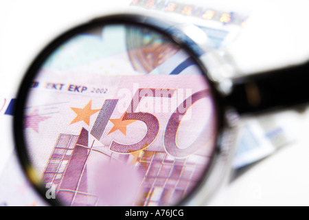 Euro banknotes under magnifying glass, close-up Stock Photo