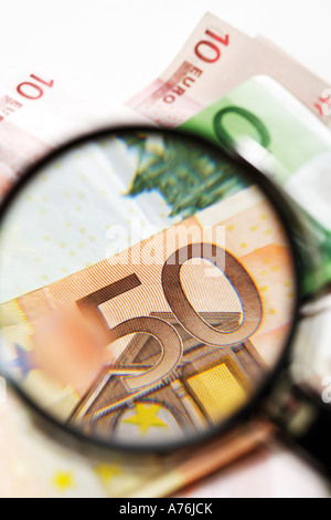 Euro banknotes under magnifying glass, close-up Stock Photo