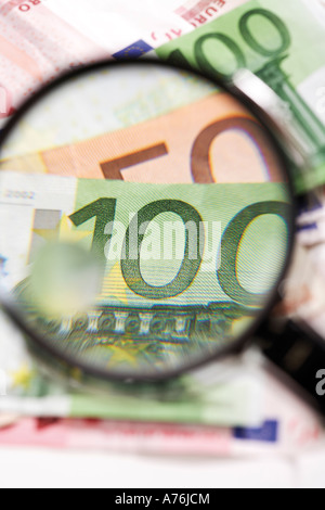 Euro banknotes under magnifying glass, close-up Stock Photo