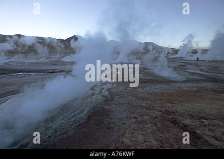 Just before sunrise at the geysers - an eerie landscape at the El Tatio Geyser Field in Chile. Stock Photo