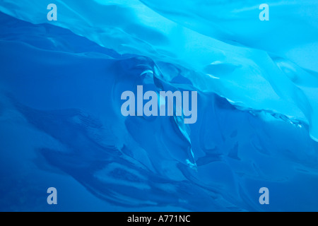 A view from underneath a glacier looking up at the ice above. Stock Photo