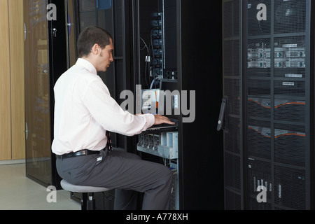 Technician working in server room Stock Photo