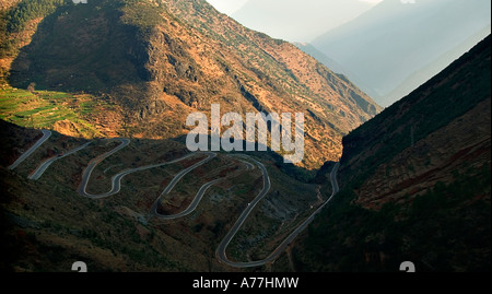 The road to Lue Gue Hue through the mountains. This is the main road carrying two way tracffic including large trucks. Stock Photo