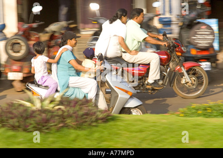 Families on mopeds in the rush hour not wearing any crash helmets - very common in India ! Stock Photo