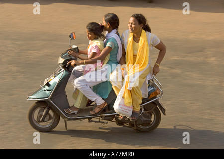 3 females (sisters ?) on a moped not wearing any crash helmets - very common in India ! Stock Photo