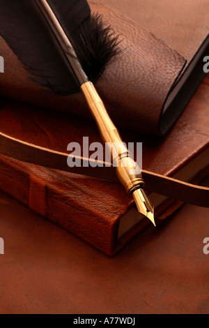 Antique feather quill on stack of books Stock Photo