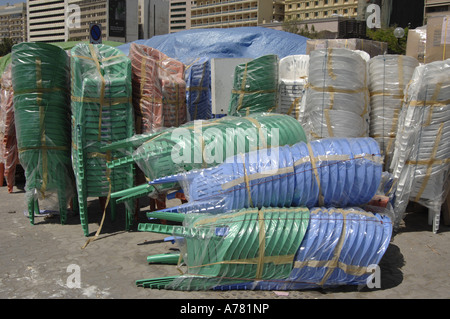 Plastic chairs on Dubai creek quayside Stock Photo