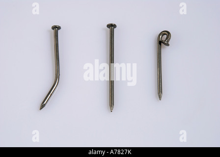 straight and bent nails on white background Stock Photo