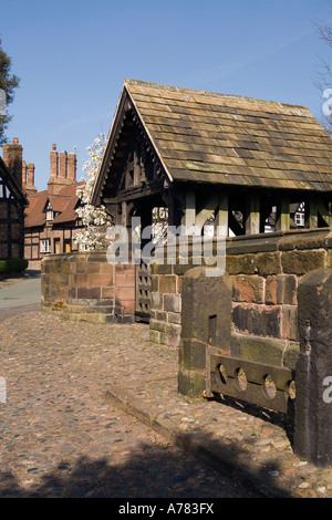 UK Cheshire Vale Royal Great Budworth village stocks at St Marys Parish church lych gate Stock Photo