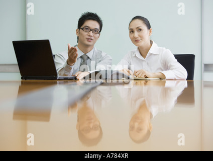 Two business executives working in conference room Stock Photo