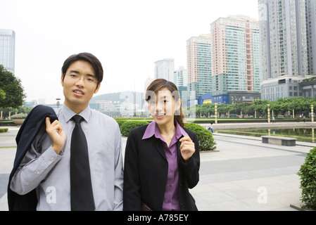 Two young business executives walking in office park Stock Photo