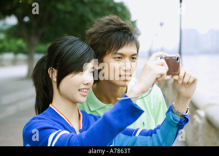 Young couple, taking photo with digital camera Stock Photo