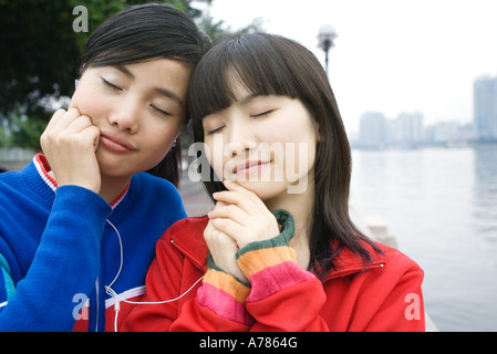 Two Asian Girls Sharing A Guy