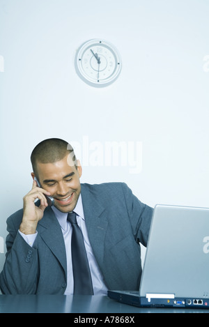Businessman using cell phone and laptop Stock Photo
