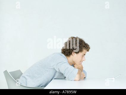 Teenage boy with bad posture using mobile phone on color background Stock  Photo - Alamy