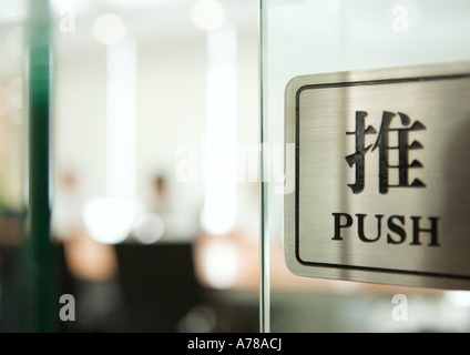 Push sign on door in English and Chinese Stock Photo