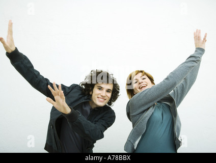 Two young adults, dancing, white background Stock Photo