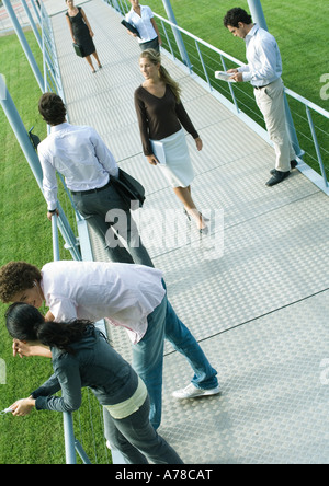 Group of people involved in different activities on walkway Stock Photo