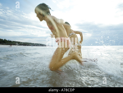 Children racing in shallow water Stock Photo