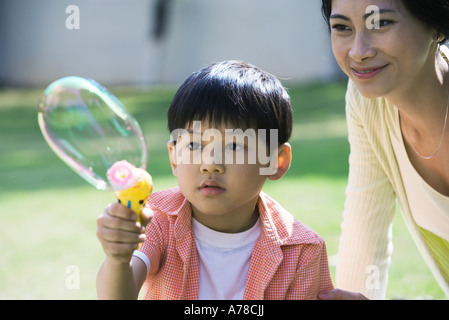 Mother and son making bubbles Stock Photo